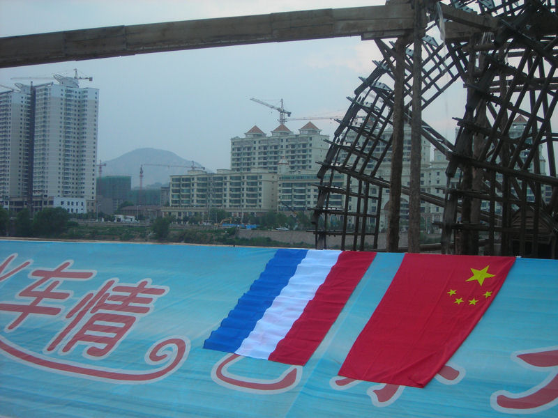 The Lanzhou Waterwheel Museum and Exhibition Hall in het centrum van Lanzhou, direct gelegen aan de Gele Rivier met de Chinese en Nederlands vlag.